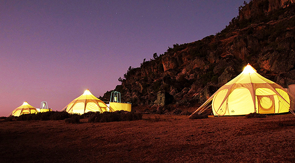An evening view of a tented camp of dome tents provided by travel company, An African Canvas